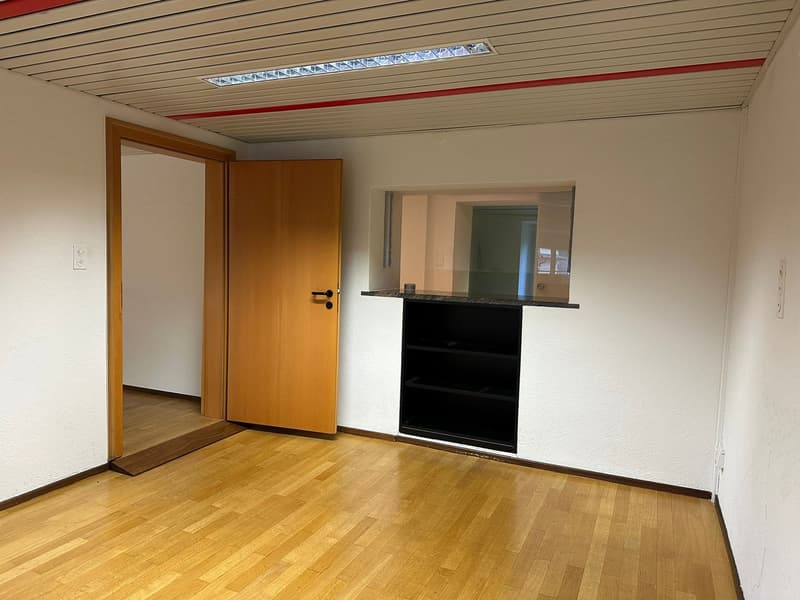 empty room, wooden floor, white walls, wooden door, small window, built-in shelf