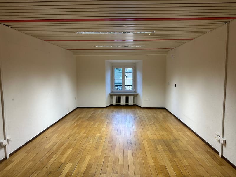 empty room, wooden floor, white walls, window with balcony, radiator