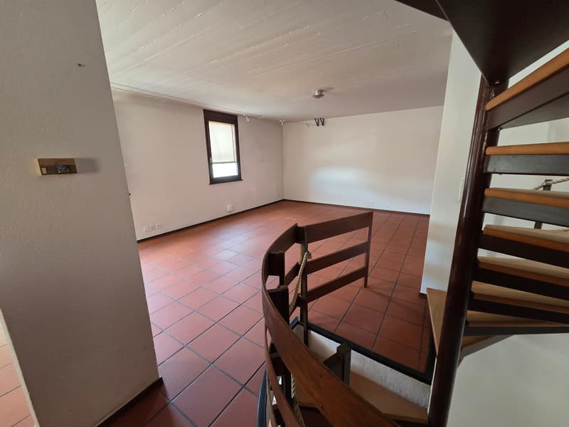empty room, red tiles, white walls, spiral staircase, window