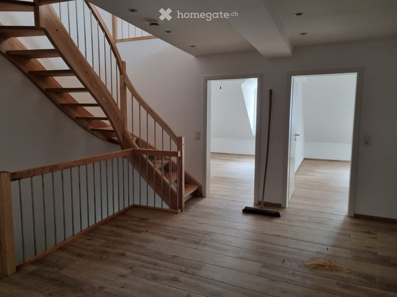 Empty room, wooden stairs, hardwood flooring, broom and dustpan