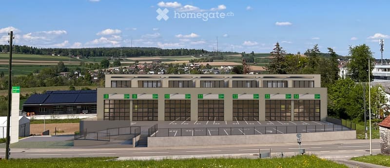 Modern building with several windows and numbered units, parking area in front