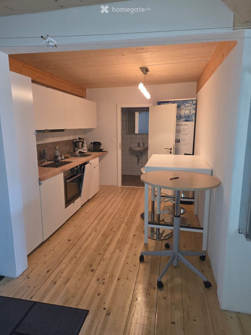 fully equipped kitchen with white cabinets, countertop, modern appliances, tiled floor