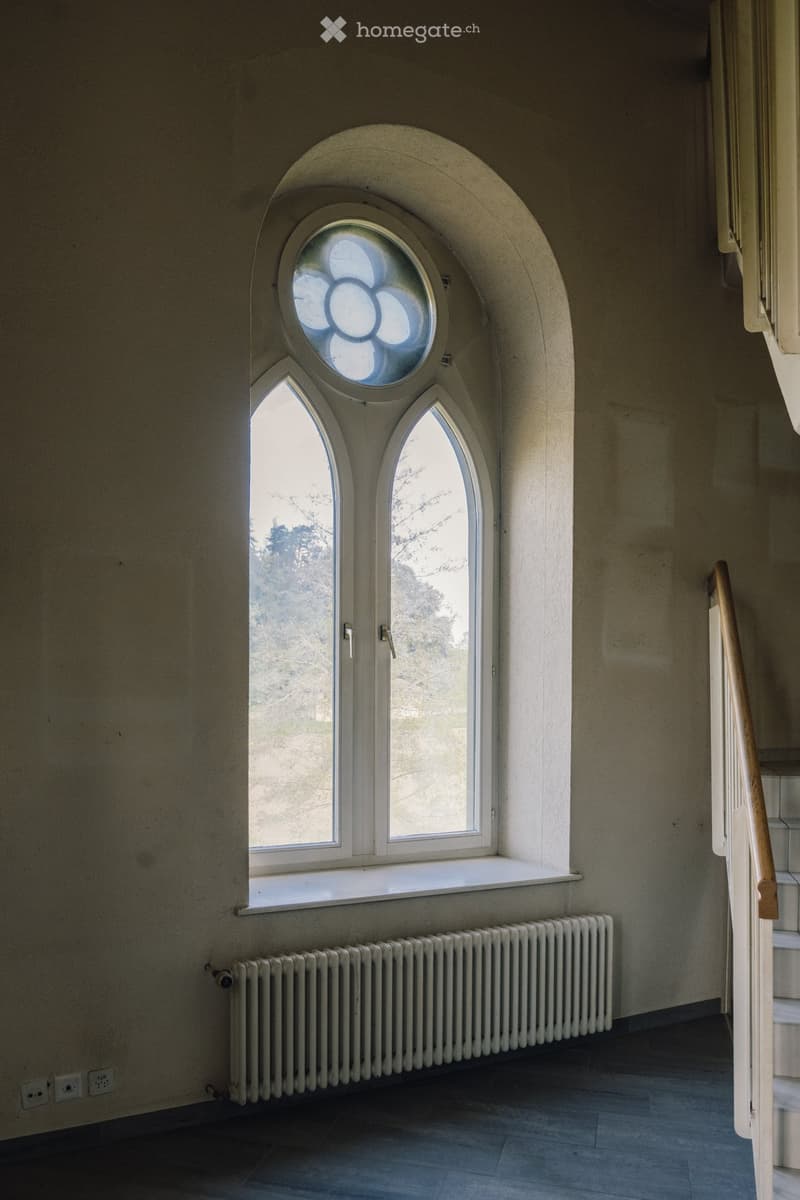 arch window, white radiator, wooden handrail, power outlets