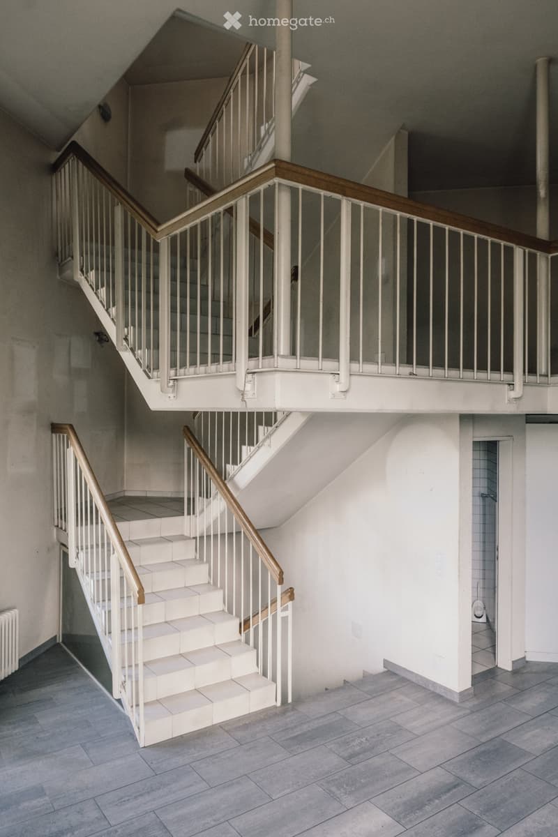 two-level staircase, white tiles, white walls, gray flooring