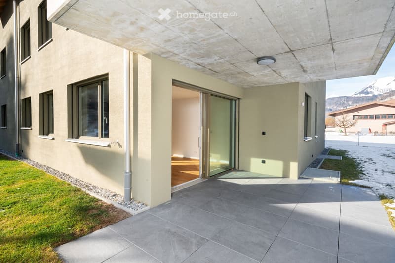 raised ground floor, grey tiles, glass door, small grassy area