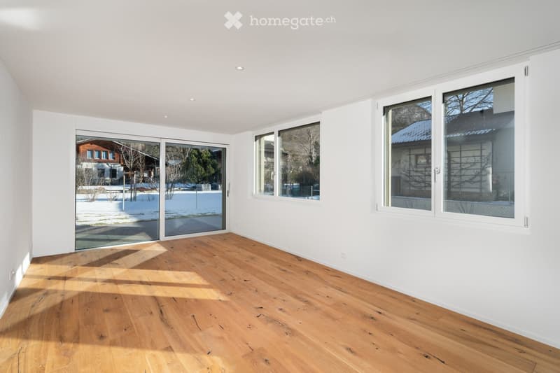 wooden floor, white walls, sliding glass doors to balcony, three large windows