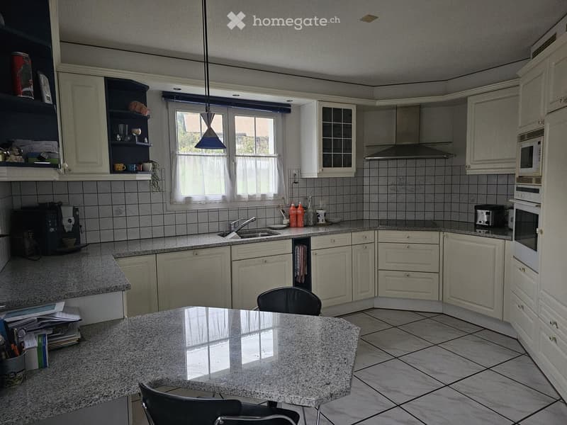 modern kitchen, granite countertops, large island, open shelves, white cabinets, tiled floor, stainless steel appliances, dishwasher, microwave, coffee machine, gas stove, range hood, sink with faucet