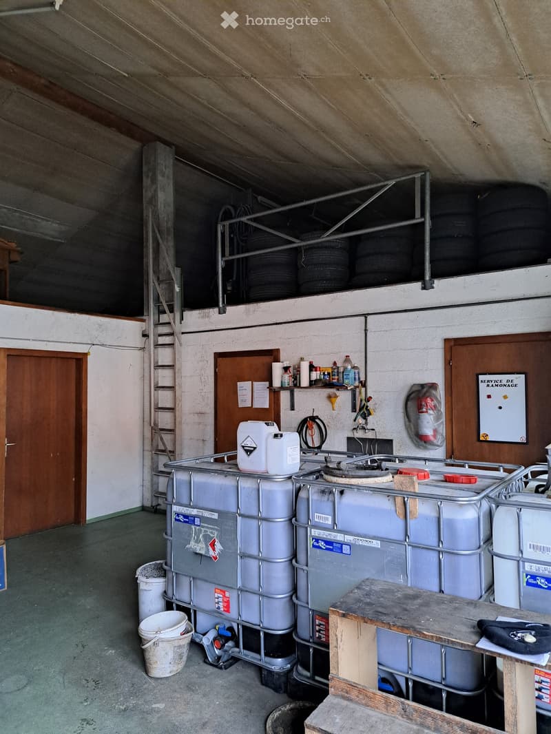 industrial room with metal racks, containers, and buckets on the floor