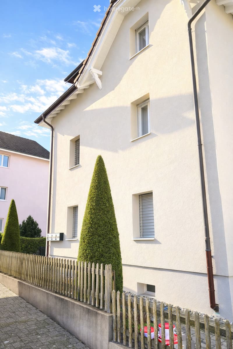 2 story house, beige wall, white windows, brown chimney, wooden fence