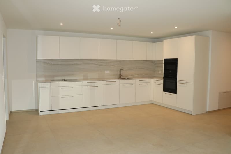 modern kitchen with built-in appliances, white cabinets, marble countertop, tiled floor
