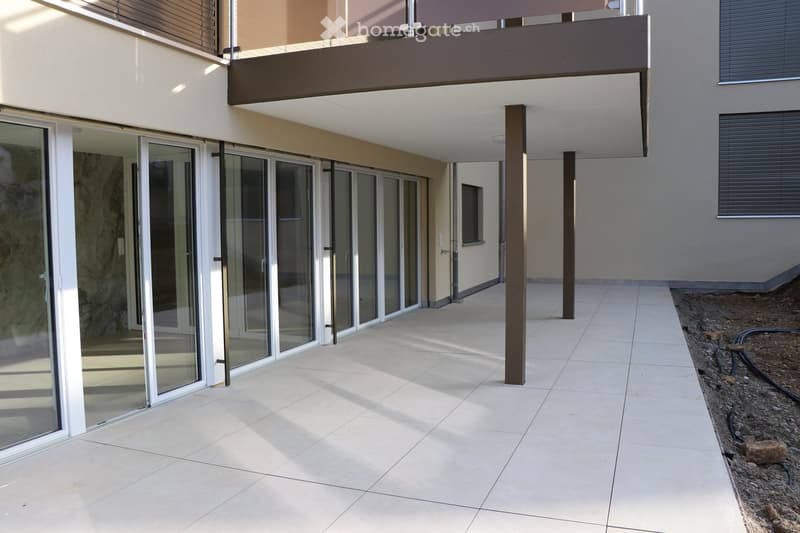 tiled walkway, large glass doors, balcony, brown pillars