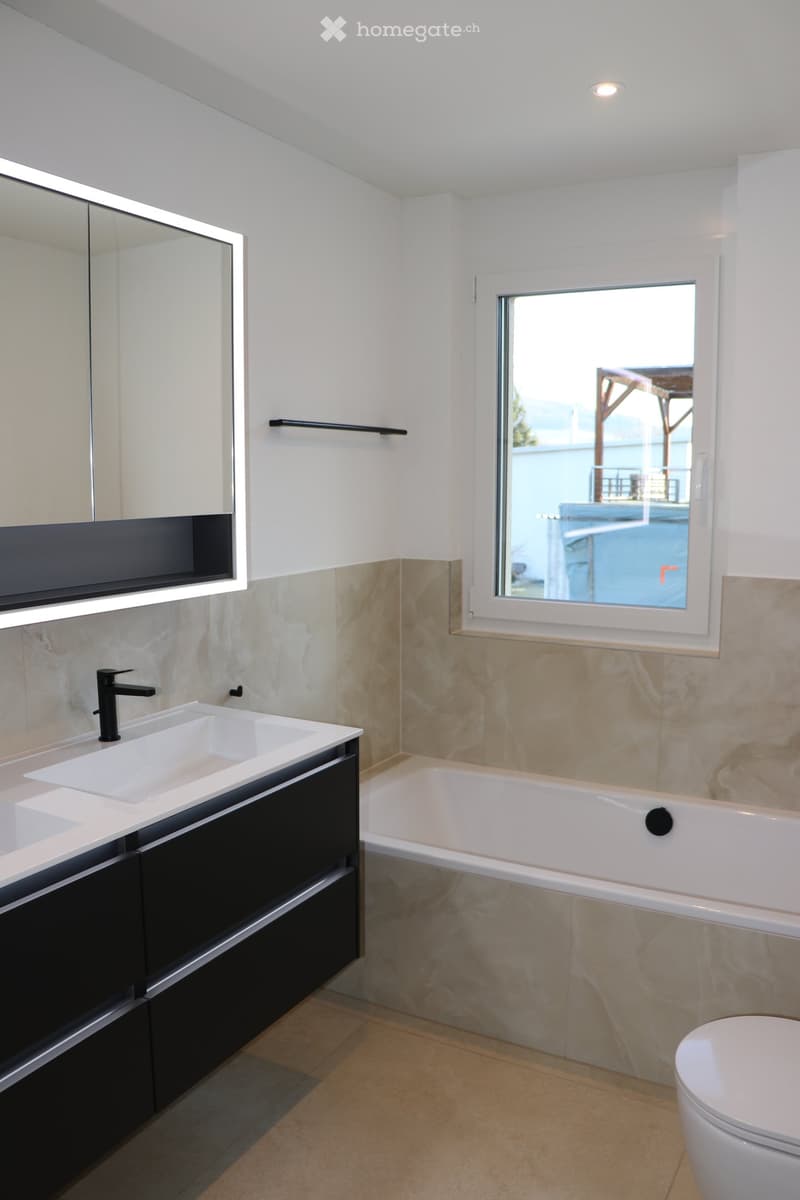 modern bathroom, white bathtub, two sinks, modern cabinet, modern faucet, window, mirror, toilet