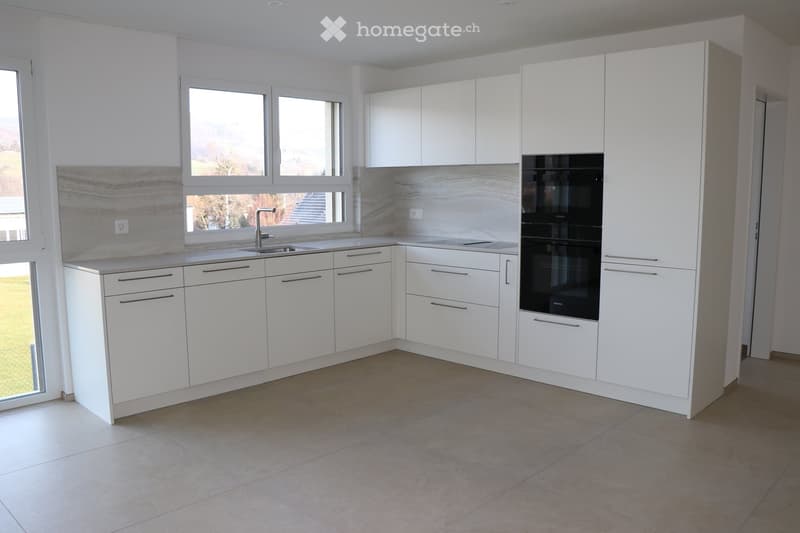 white kitchen, double sink, granite countertops, built-in double oven, floor-to-ceiling windows