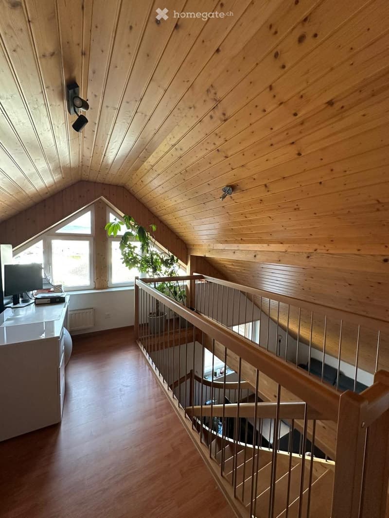 wooden ceiling, windows, staircase, table with monitor, potted plant, white cabinet