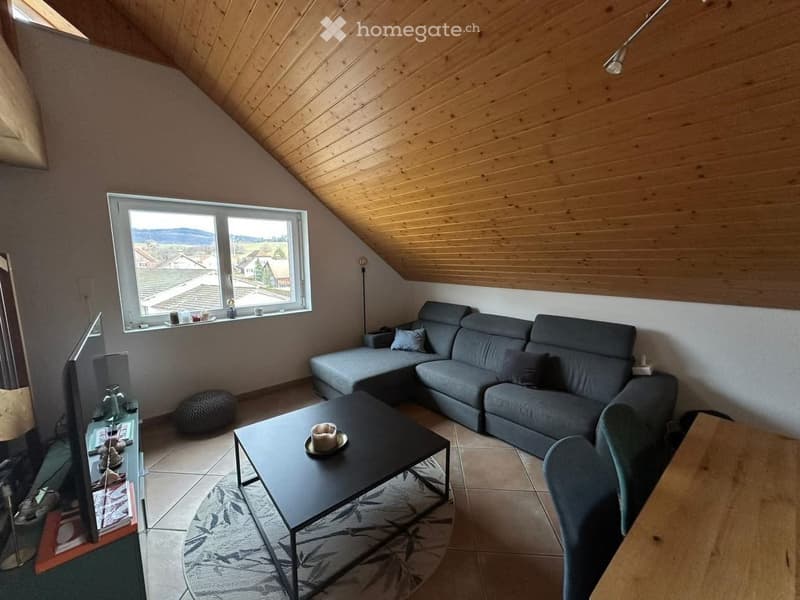 Living room: sectional sofa, coffee table, TV, rug, armchair, wooden table, lamp, window