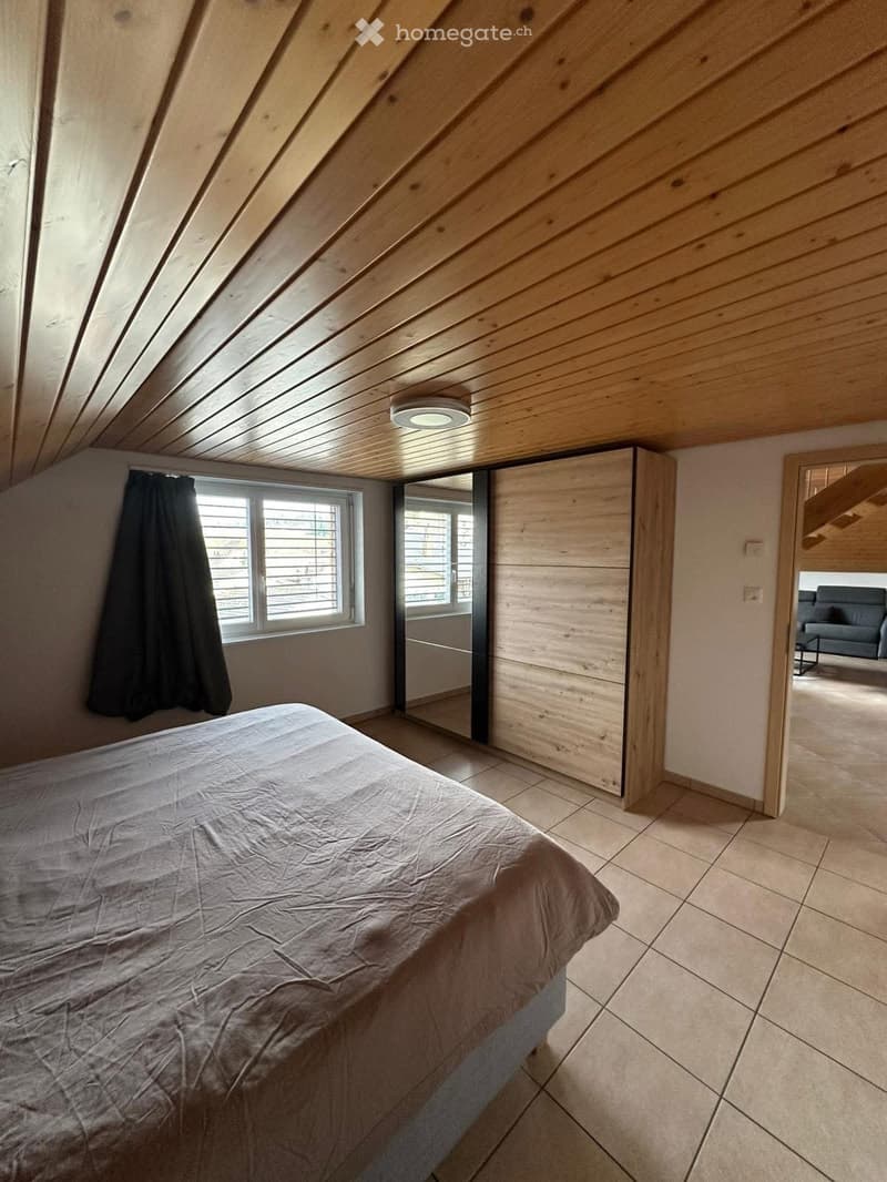 Bedroom with a bed, closet, large window, and tiled floor