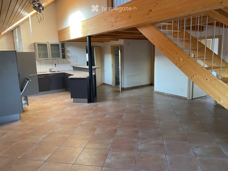 Spacious kitchen, tiled floor, ceiling beams, large kitchen island, open stairs