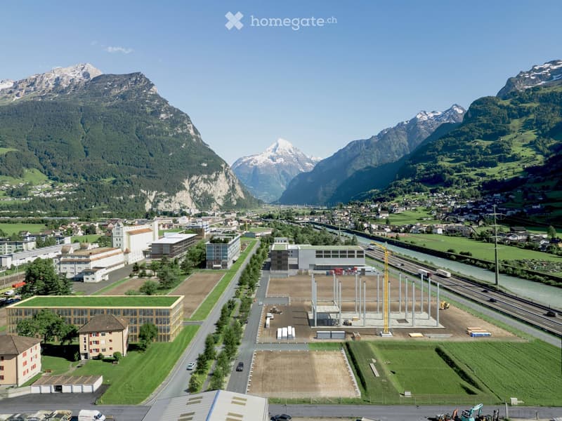 cityscape with multiple buildings, mountainous terrain, ongoing construction, river, road