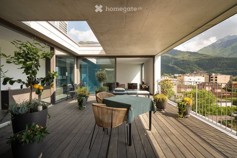 wooden deck, table, chairs, plants, railing, mountain view