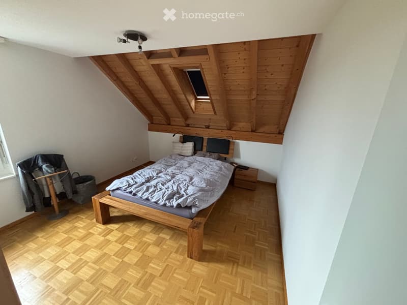 bedroom with wooden bed, wooden floor, wooden ceiling, window with clothes stand