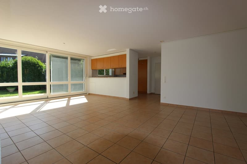 open plan living and dining area, large windows, sliding glass door, leading to balcony