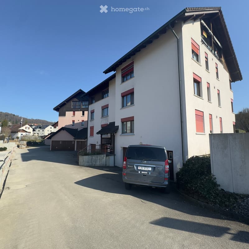 3 story building, white exterior, red shutters, garage, car parked in front