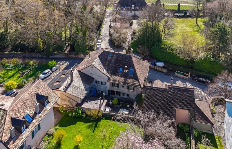 large house, multiple roofs, solar panels, multiple parking spaces, terrace, garden, swimming pool, fireplace, view