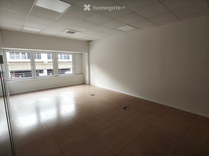 empty room, white walls, wooden floor, large windows, ceiling lights