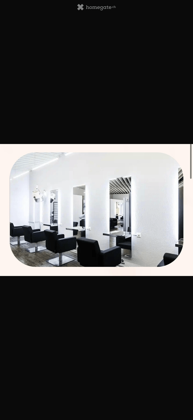 modern salon with white walls, black chairs, mirrors, tables, and ceiling lights