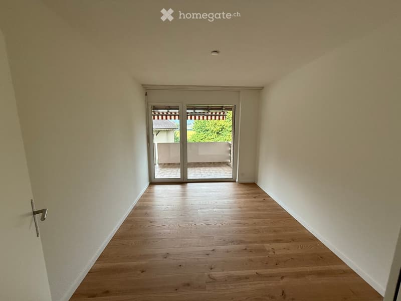 empty room, wooden floor, white walls, sliding glass doors, balcony