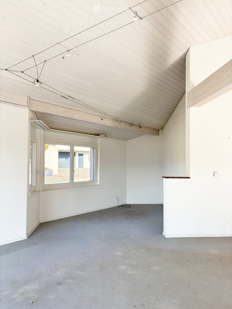empty room, white walls, wooden ceiling, windows, power outlets, gray floor