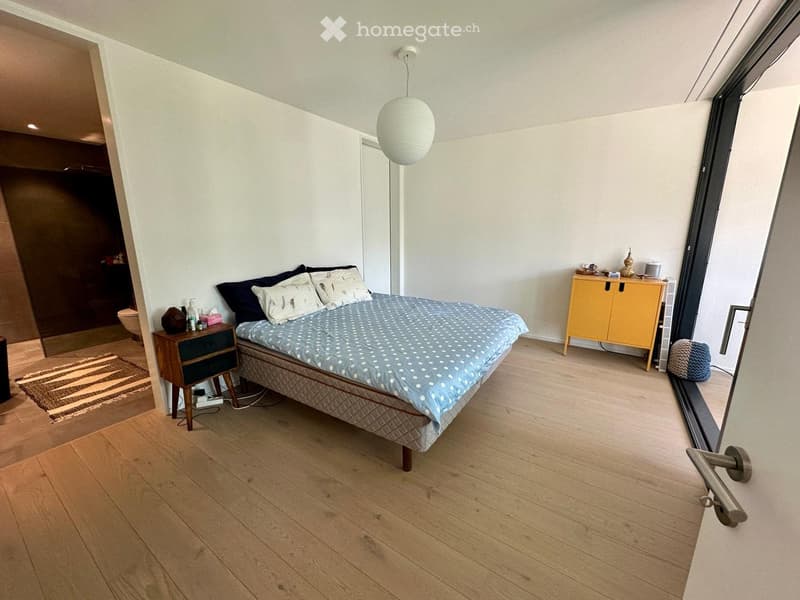 Bedroom with bed, nightstand, cabinet, rug, and a balcony