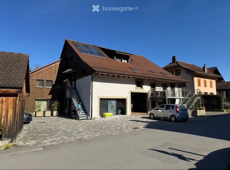 2 story house, brown roof, solar panels, garage, car parked in front
