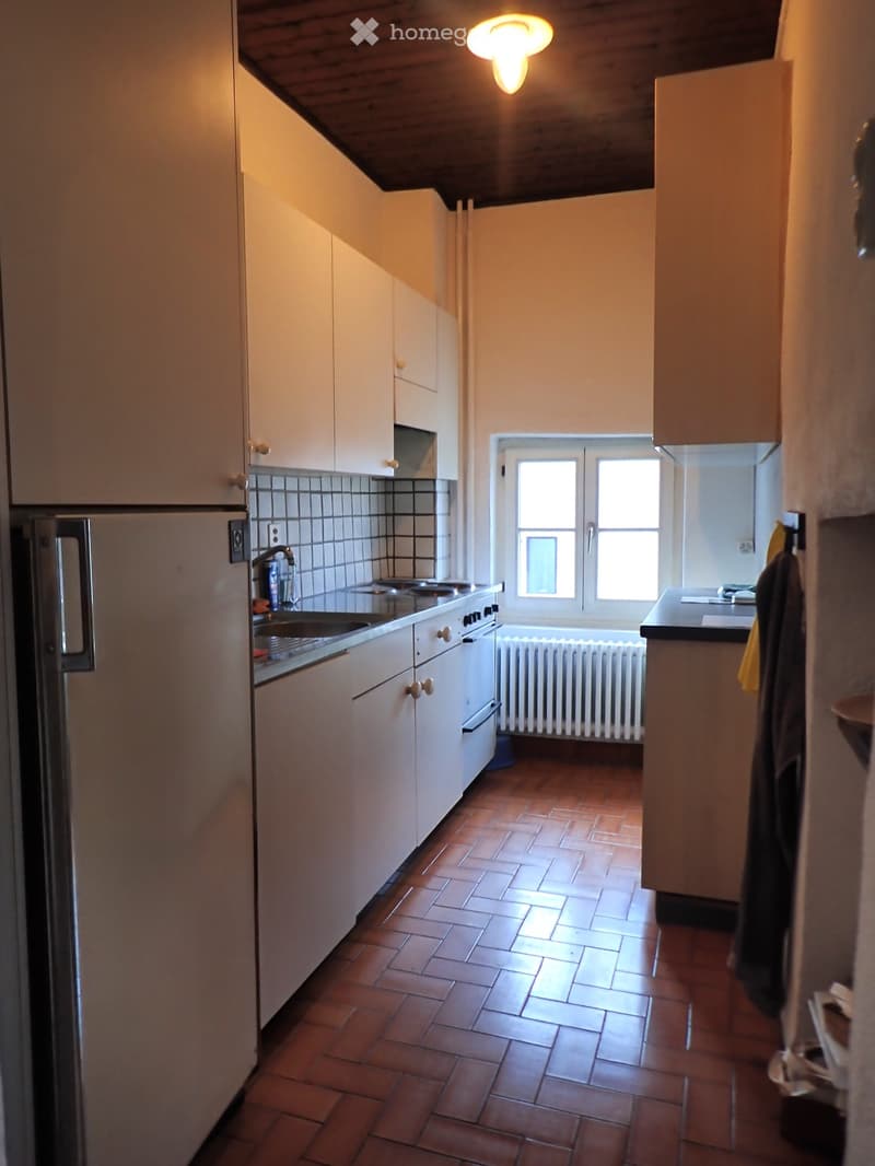 kitchen with white cabinets, tiled floor, refrigerator, sink, oven, window, radiator
