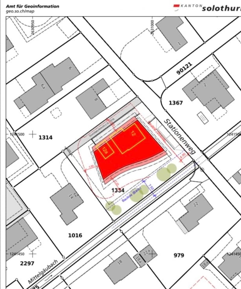 Floor plan with multiple buildings and lots, including a central red-highlighted area