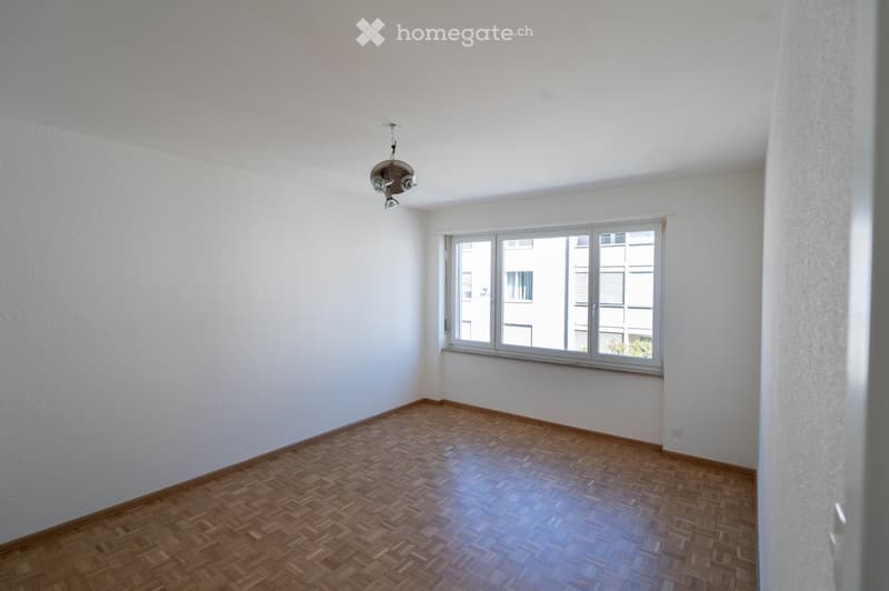 empty room, white walls, wooden floor, large window, ceiling lamp