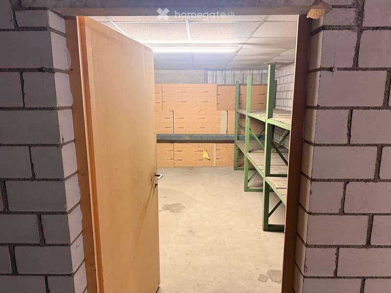 Storage room with a door, shelves, and boxes