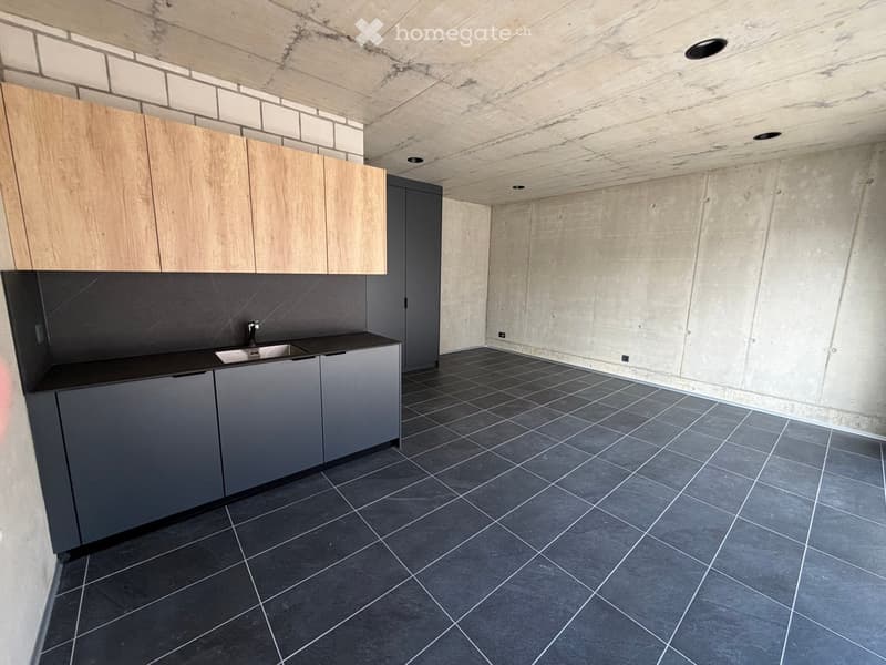 modern kitchen with wooden cabinets, black countertops, stainless steel sink, tiled floor
