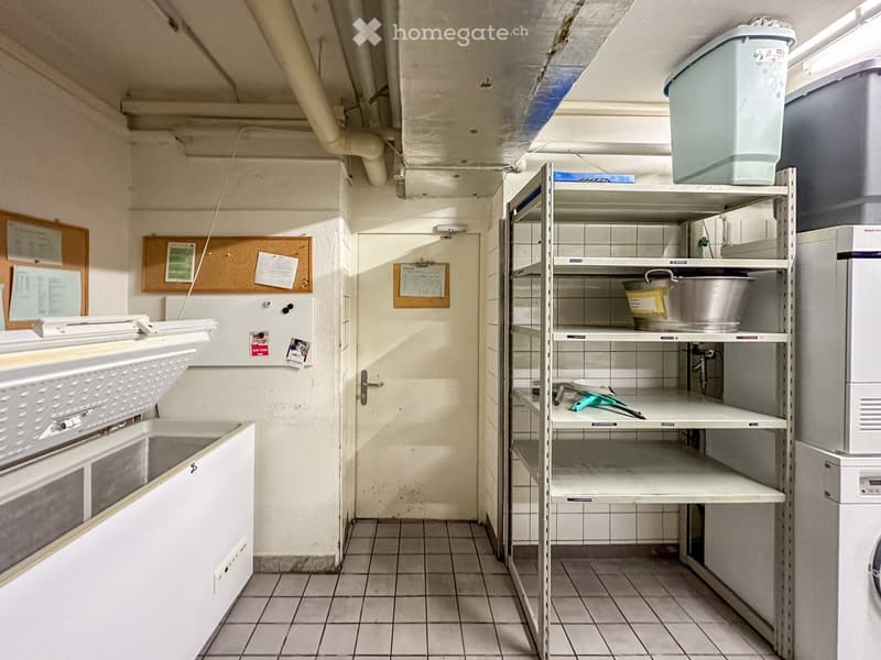 Laundry room with washing machine, dryer, and shelves