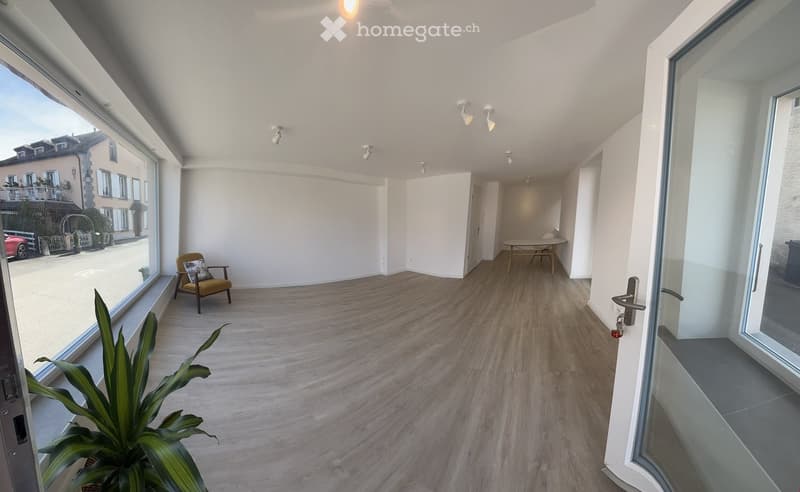 empty room, large windows, wooden floor, white walls, ceiling lights, table and chairs