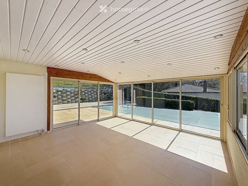 empty room with sliding glass doors, tiled floor, white ceiling, view of swimming pool