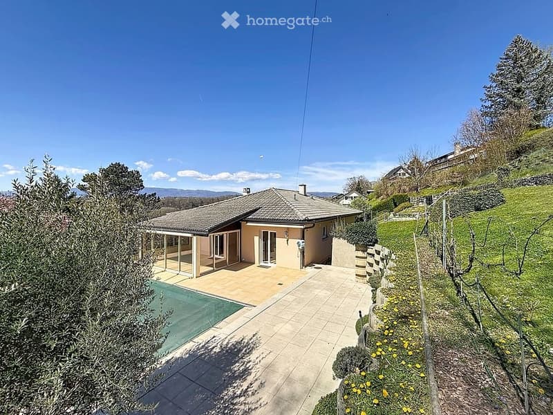 Detached house, tiled roof, glass doors, swimming pool, paved patio, garden, trees, hillside