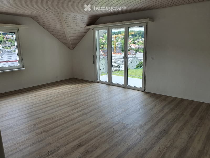 Unfurnished Room. Empty room with wooden floors, white walls, and large windows leading to a balcony.