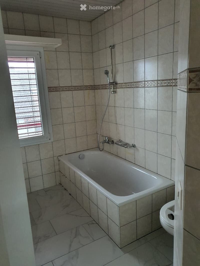 Bathroom. Bathroom with a bathtub, shower head, faucet, and toilet.