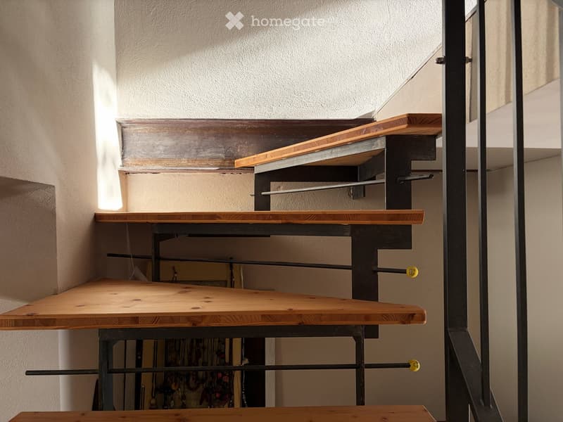 metal handrails, wooden steps, open interior space