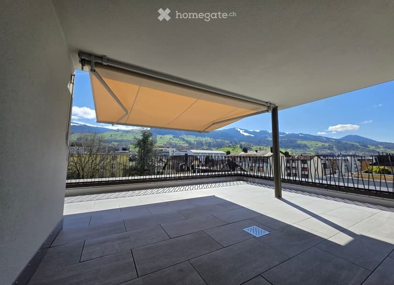 Balcony / Terrace. Balcony with tiled floor, metal railing, retractable awning, and scenic mountain view.