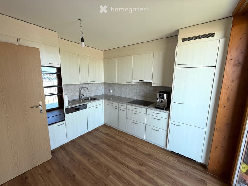 white cabinets, wooden floors, modern appliances, sink, coffee machine, and a window with view