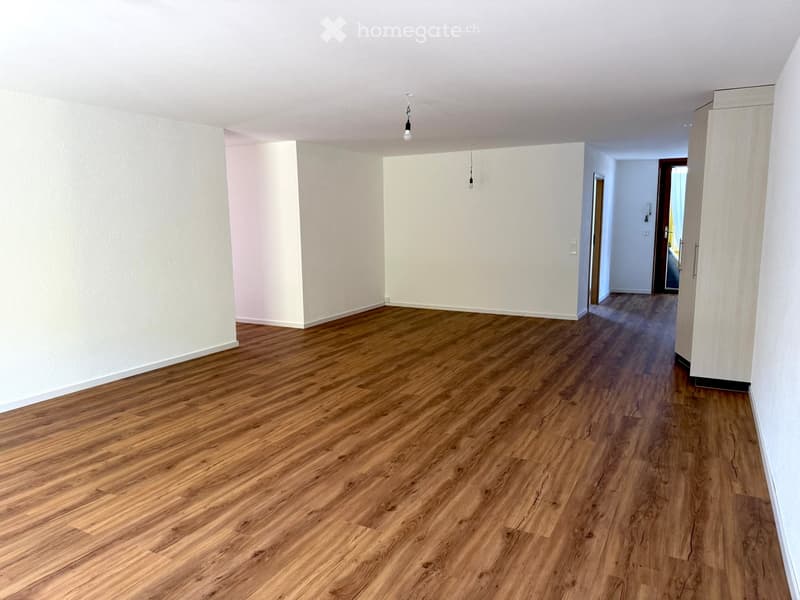 empty room, wooden flooring, white walls, small ceiling light