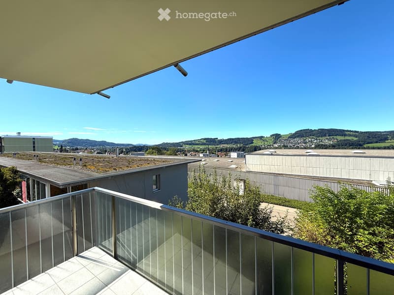 large balcony with glass railings, tiled floor, beautiful view