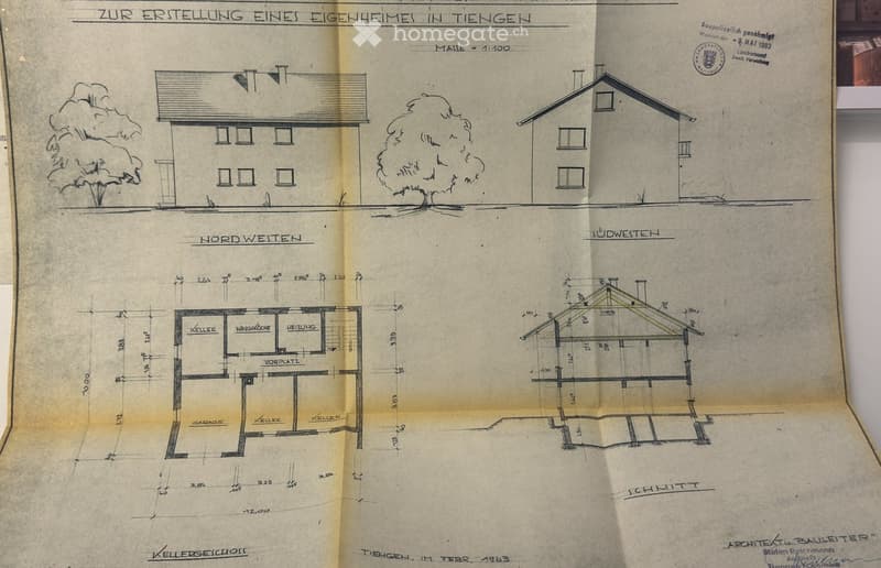 Architectural floor plan showing a house layout with labeled rooms including cellar, garage, and heating room. Includes exterior views and measurements.